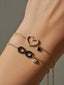 Bracciale Infinito in Oro Rosa con Diamanti Neri e Punto Luce Pendente – Herzel Gioielli